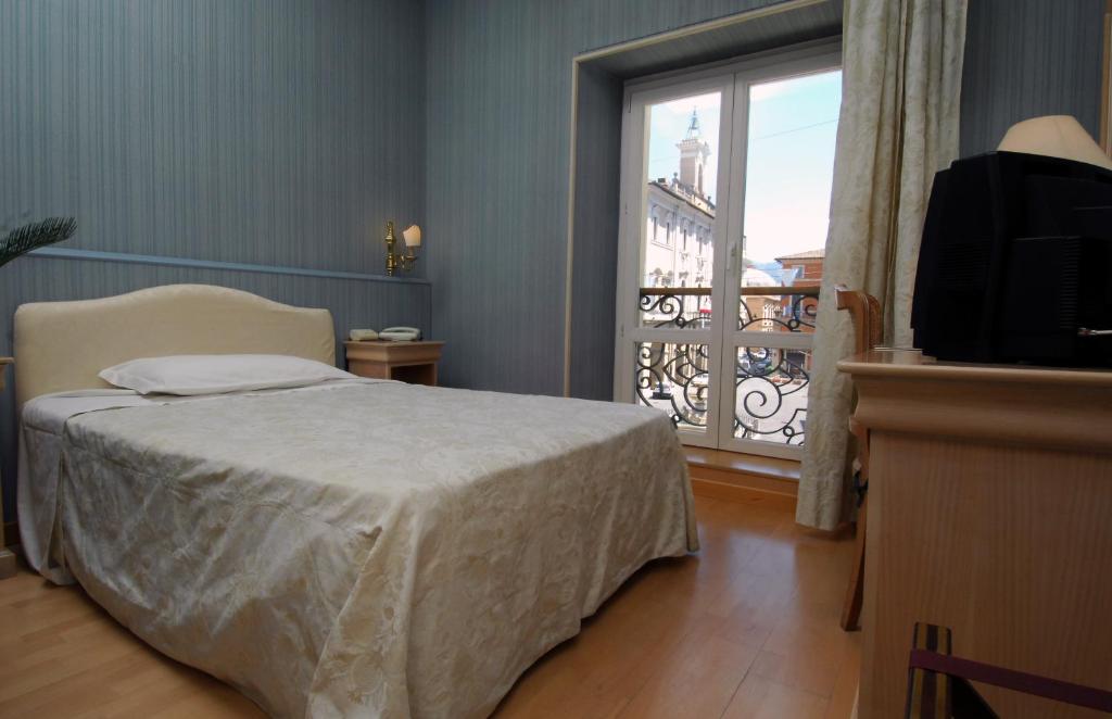 Postel nebo postele na pokoji v ubytování Grande Albergo Quattro Stagioni