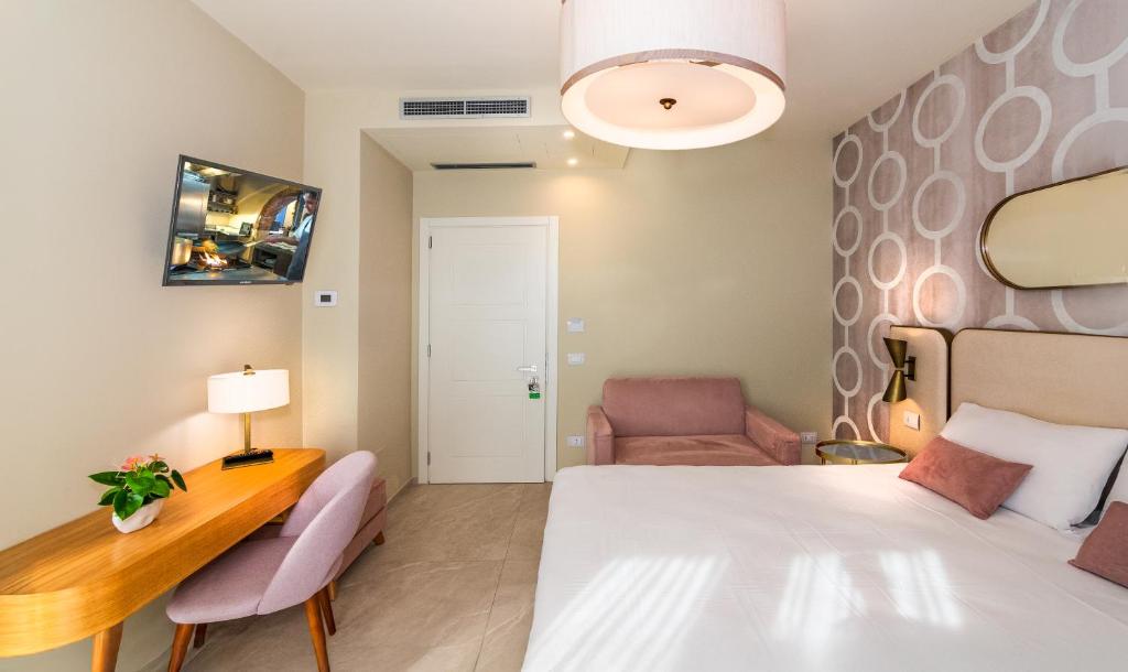 Postel nebo postele na pokoji v ubytování Hotel Mariotti