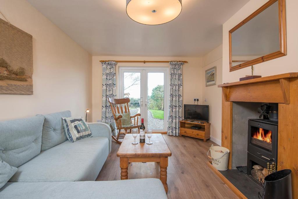 a living room with a couch and a fireplace at Afallon in Haverfordwest