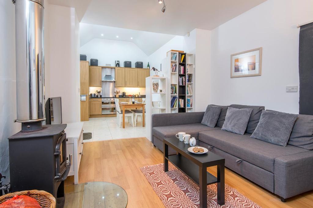 a living room with a couch and a table at Picture Cottage in Solva