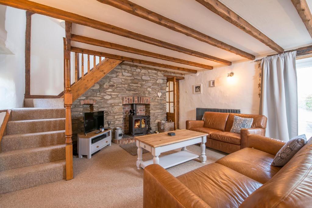 a living room with a couch and a fireplace at The Old Dairy in Haverfordwest
