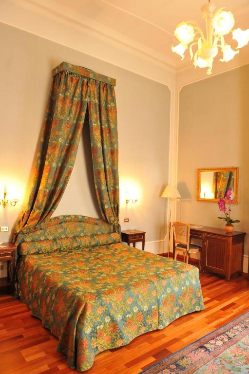Postel nebo postele na pokoji v ubytování Grande Albergo Quattro Stagioni