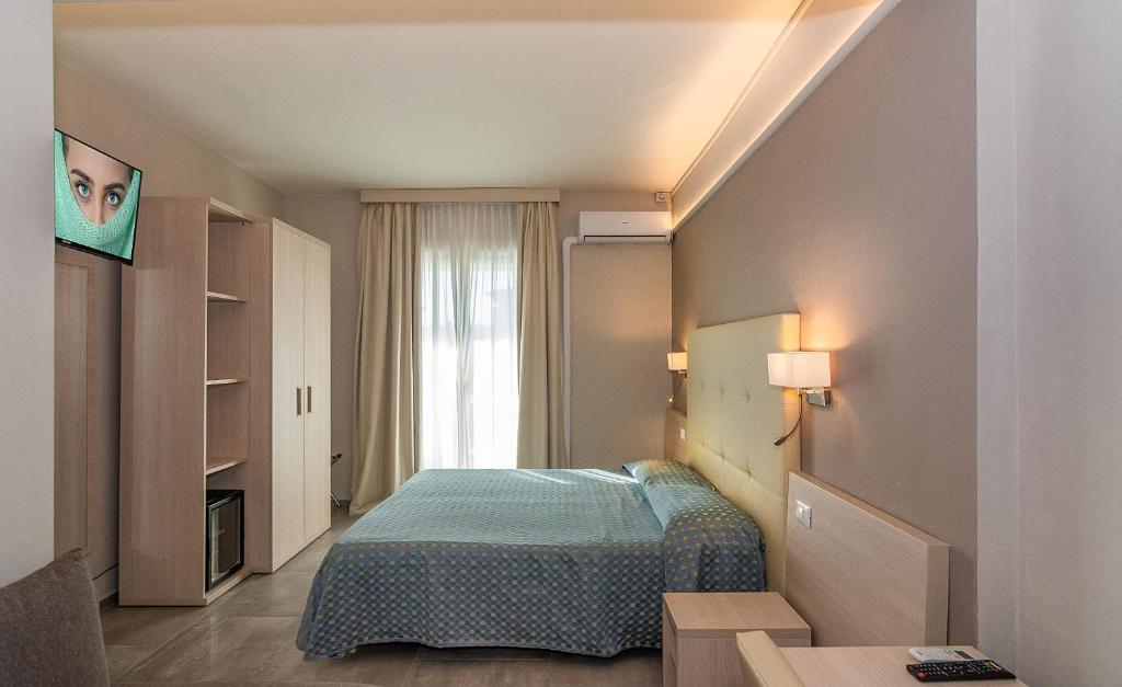 Postel nebo postele na pokoji v ubytování Hotel Mariotti