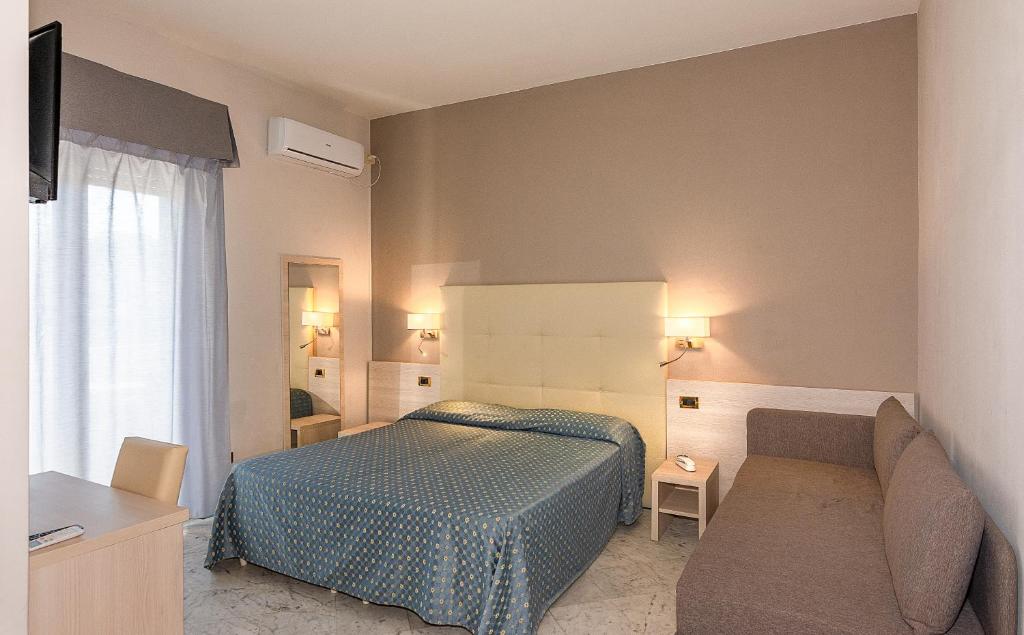 Postel nebo postele na pokoji v ubytování Hotel Mariotti