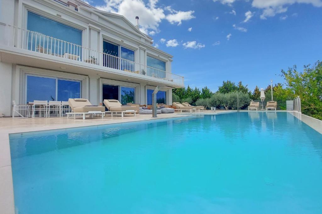 a large swimming pool in front of a house at The Mansion in Heraklio Town