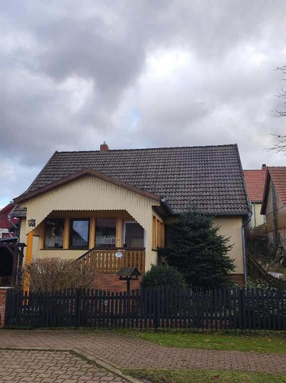 a house with a fence in front of it at Ferienhaus Anna in Allrode
