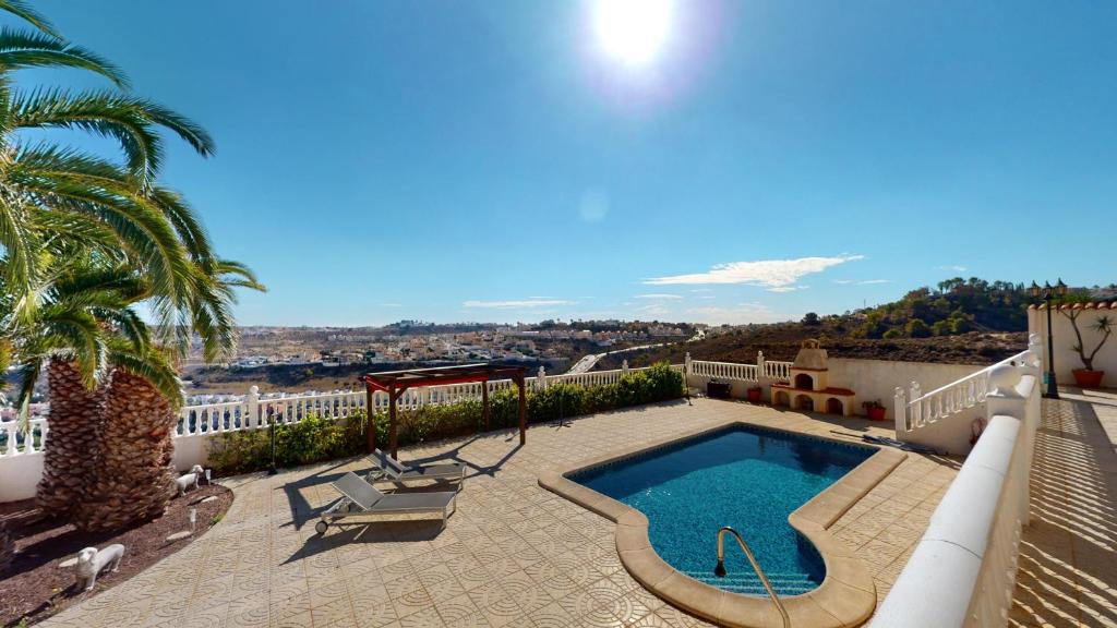 a swimming pool on the roof of a house at Villa Marqués in Ciudad Quesada