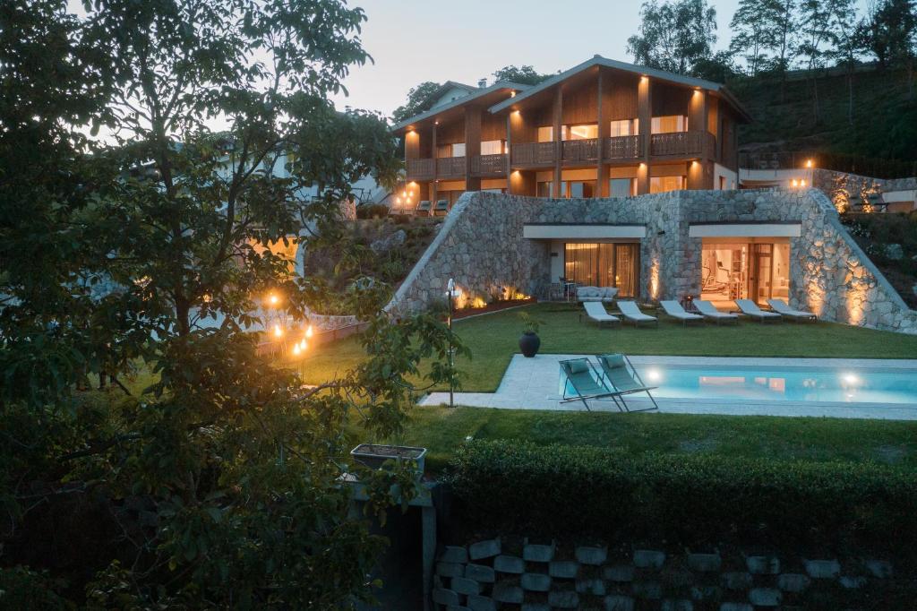 a house with a swimming pool in front of it at ANTON Nature Hideaway in Natz-Schabs