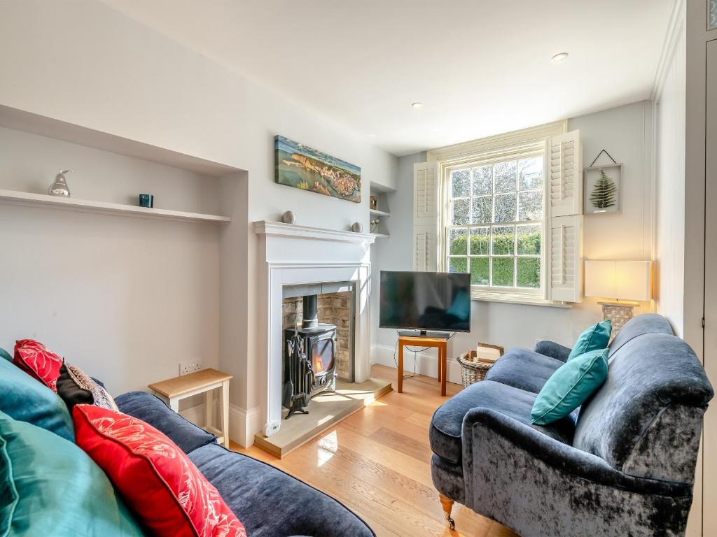 a living room with a couch and a fireplace at Ryburn House - Uk43518 in Thornton Dale