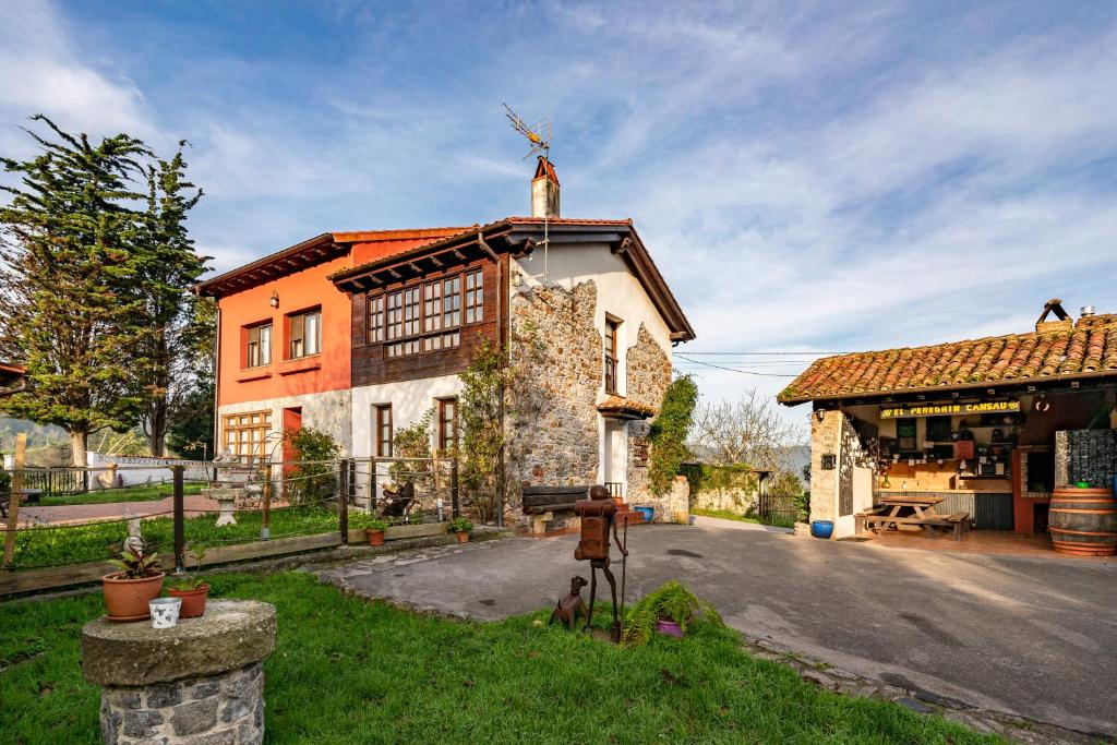 a man standing in front of a building at La Casina Del Fresnu in Onón