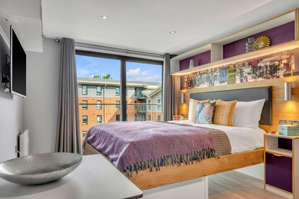 a bedroom with a bed and a large window at Practical Studio For 2 In Leeds with Free Grab&Go Breakfast in Headingley