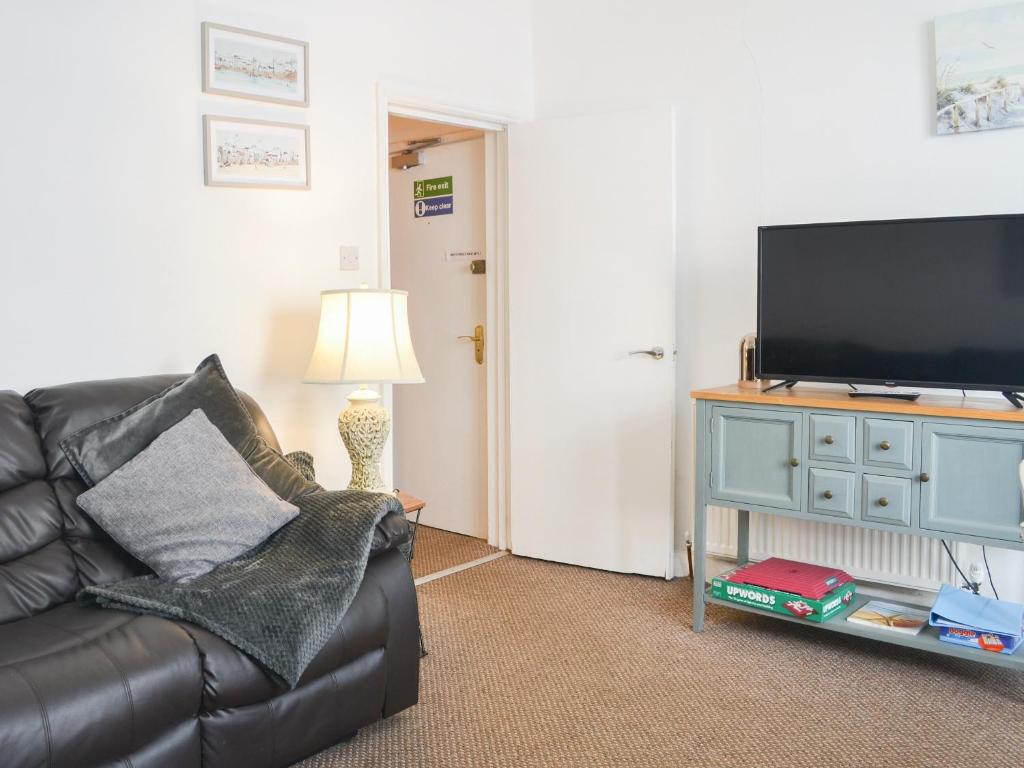 a living room with a couch and a television at Apartment 1 - Uk44165 in Bridlington