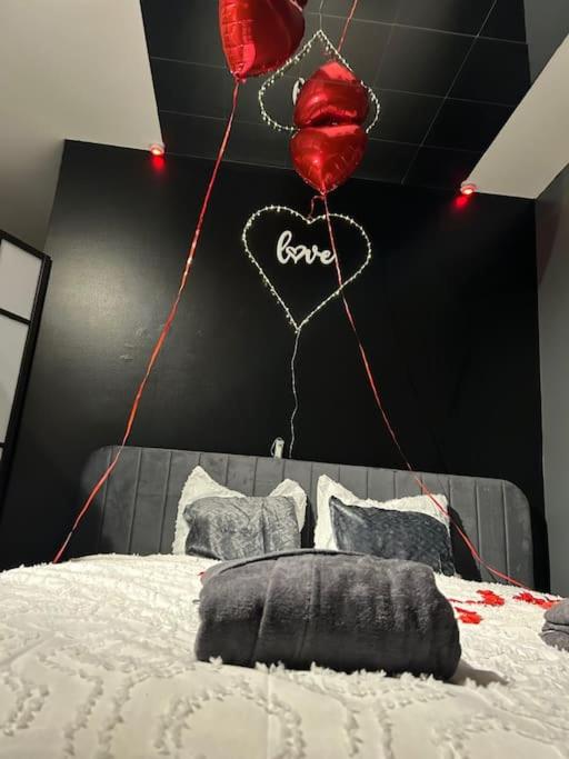a bedroom with a bed with balloons and a heart at Love-cocon sur mantes sur mante in Mantes-la-Jolie
