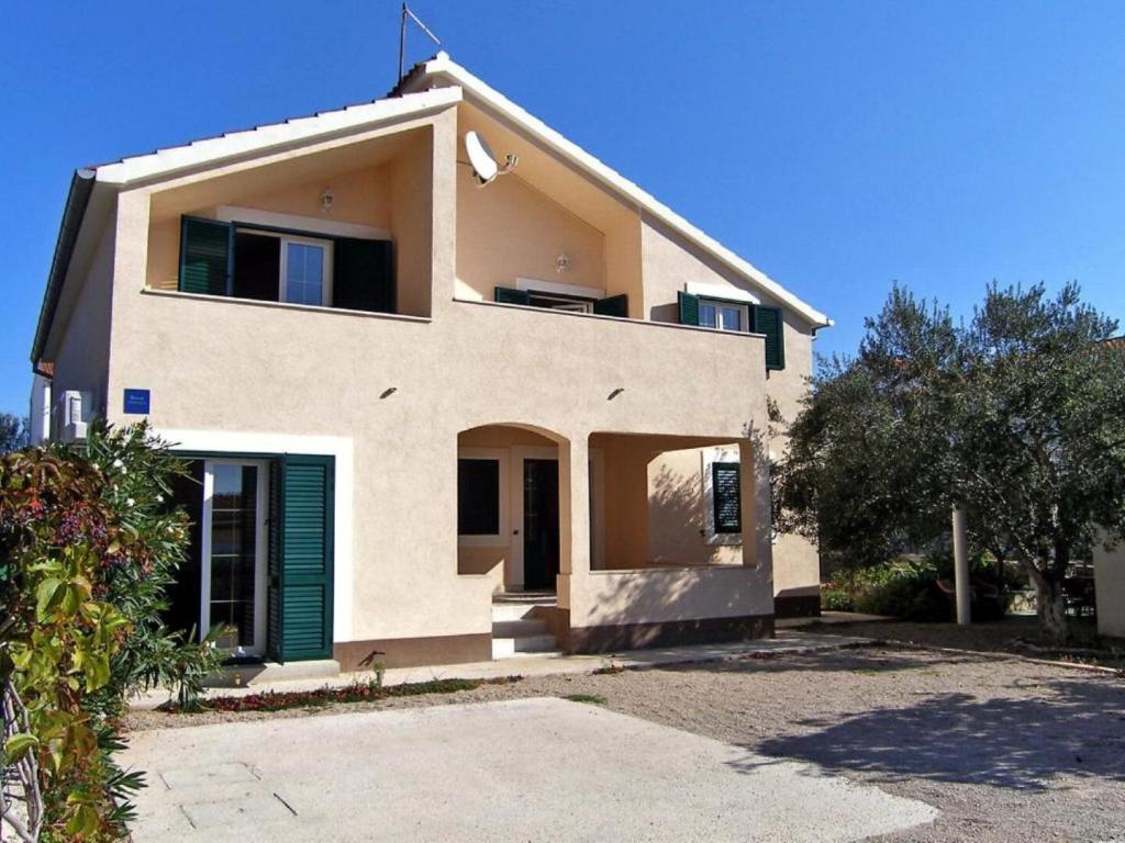 a large white house with a green door at House Vale in Jadrija