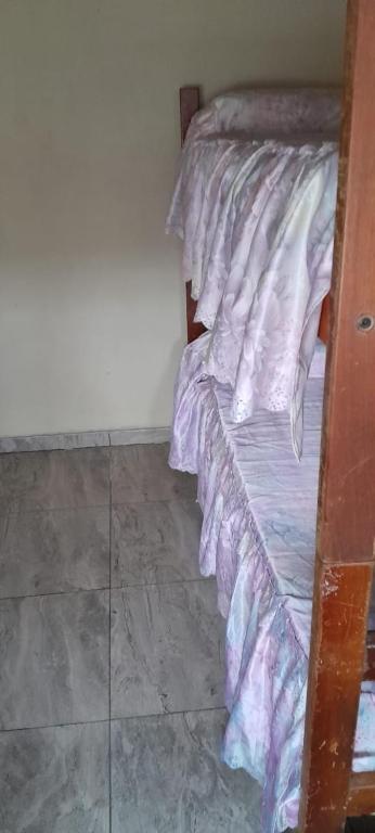 a bedroom with a bed with purple sheets on it at Casa Quequén in Quequén