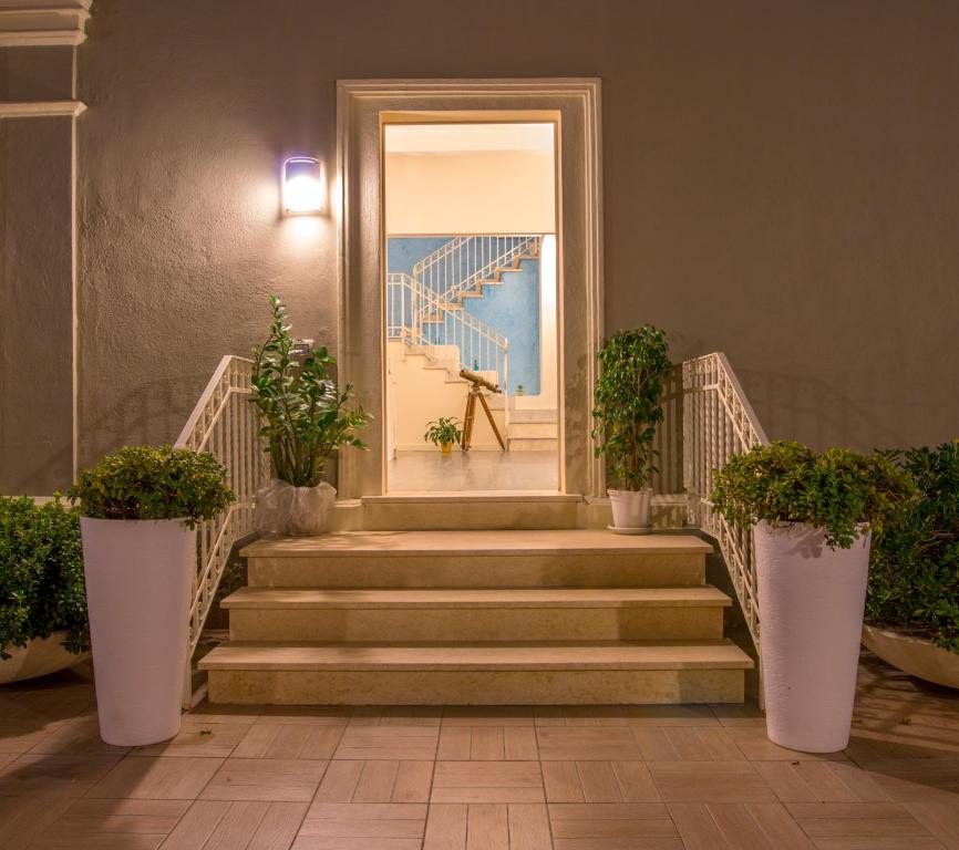 an entrance to a building with stairs and plants at Hotel La Villa Del Mare in Cagliari
