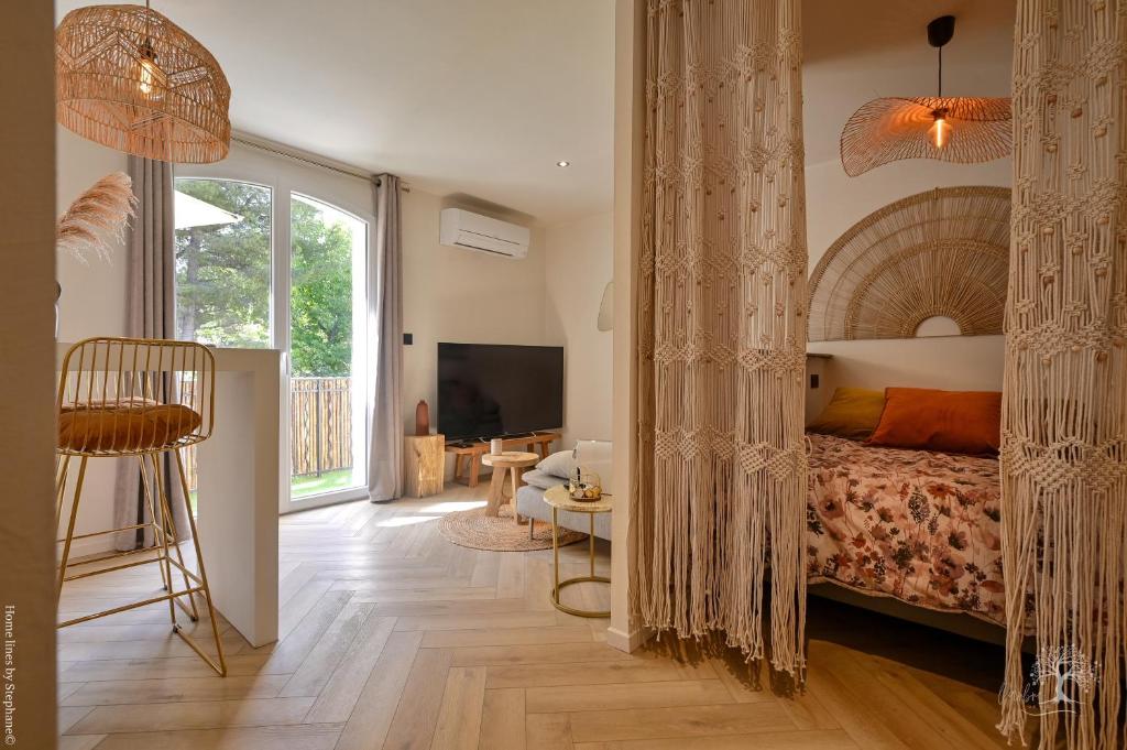 a bedroom with a bed and a large window at Une perle au bord de l'eau in La Ciotat