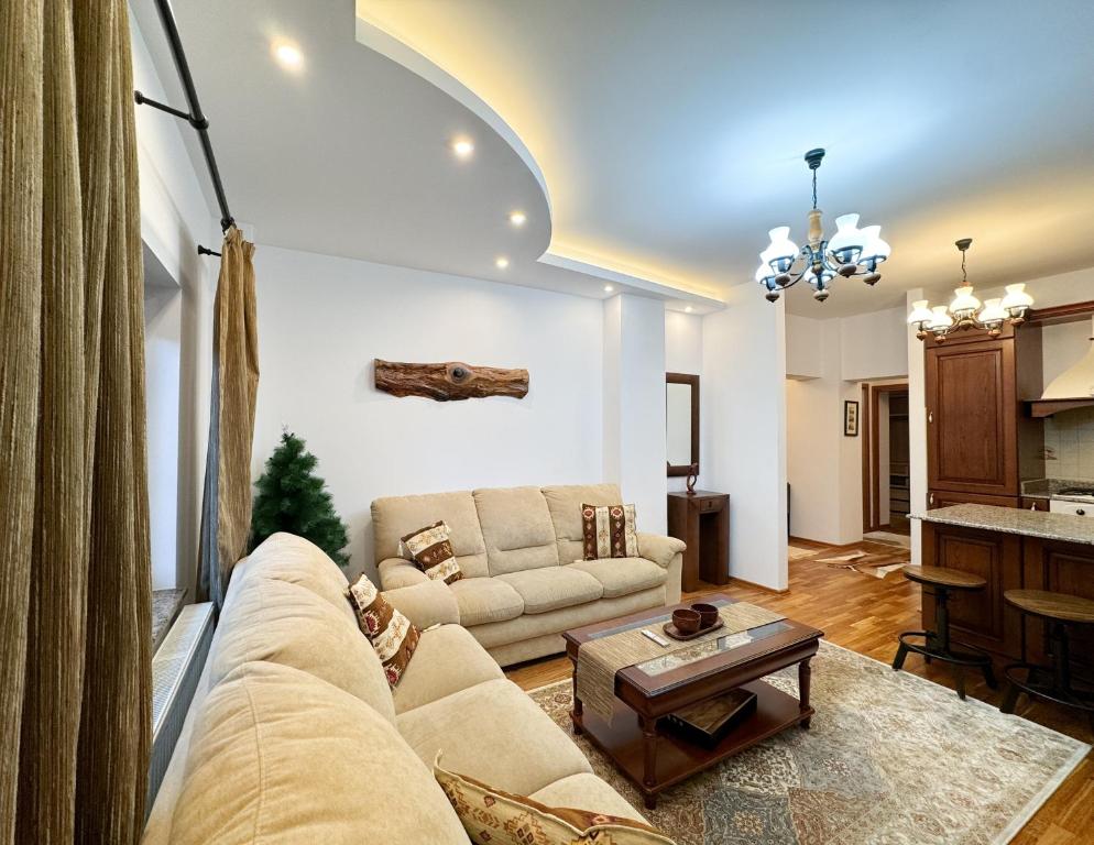a living room with a couch and a table at Impala Sinaia - Kudu in Sinaia