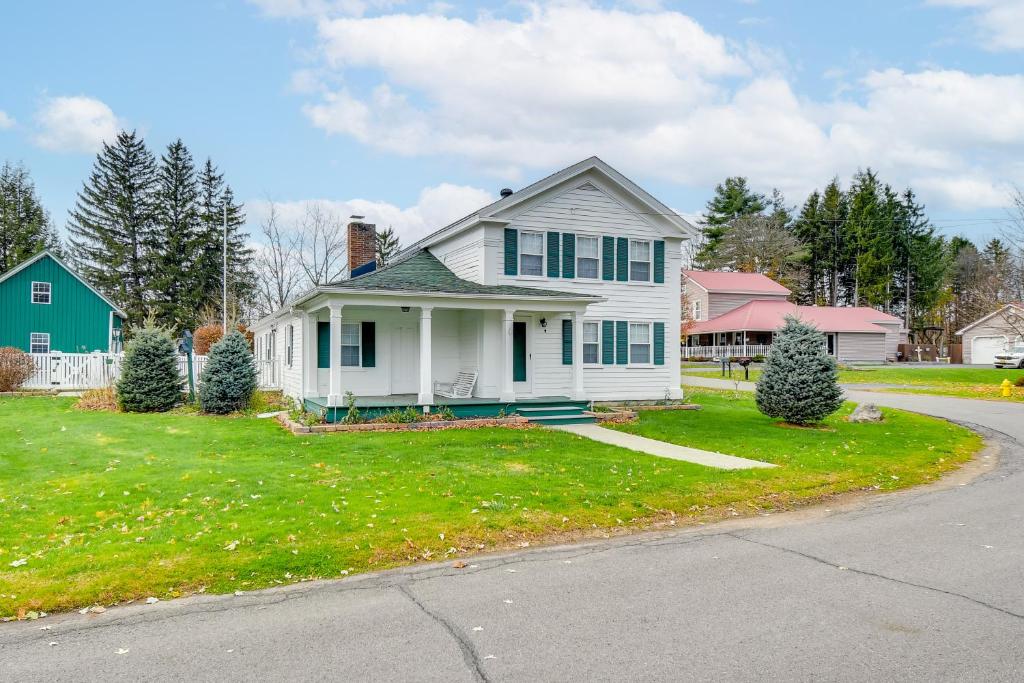 a white house on a green yard with a driveway at 5 Mi to Lake Ontario Mexico Home with Seasonal Pool in Mexico