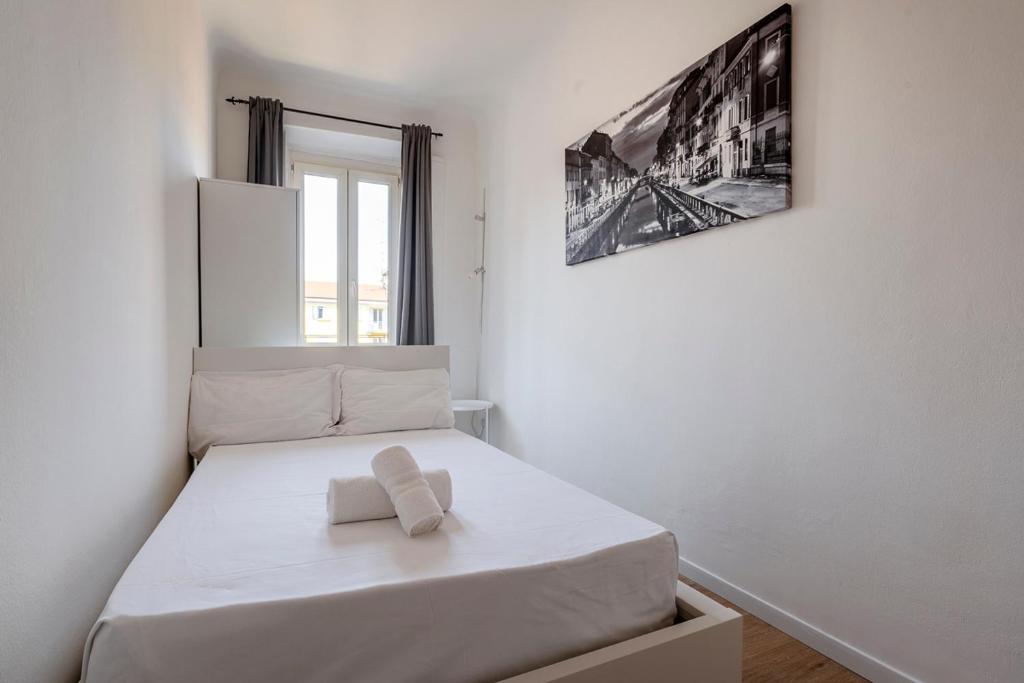 Łóżko lub łóżka w pokoju w obiekcie Exclusive 3 bedrooms apartment in Brera