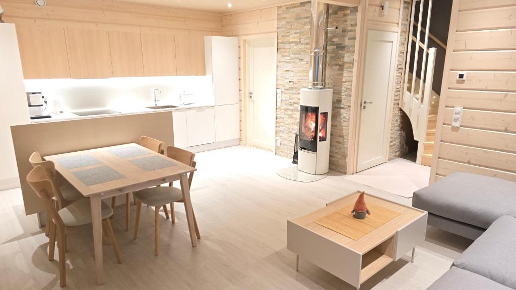 a kitchen and living room with a stove in a room at Elves Eco Design House A in Rovaniemi