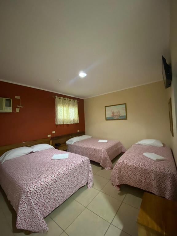 Postel nebo postele na pokoji v ubytování Hotel Residencial Panamericano