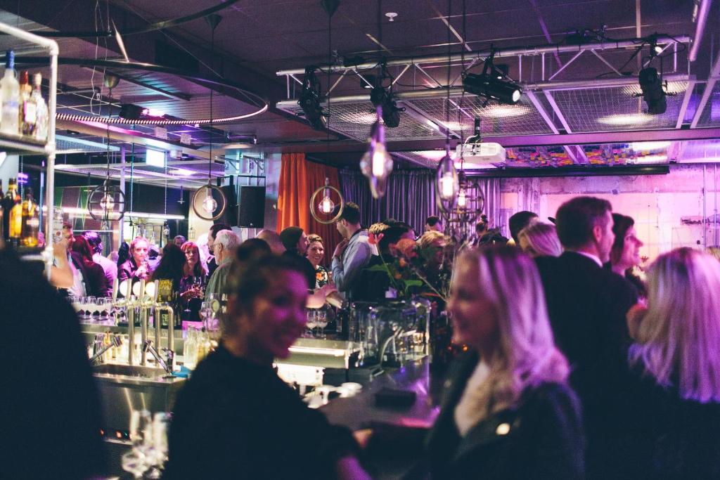 a group of people sitting at a bar at Generator Stockholm in Stockholm