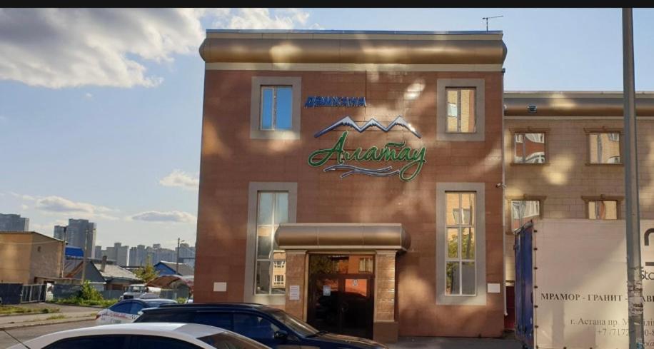 a brick building with a pharmacy sign on it at Alatau Hotel in Astana