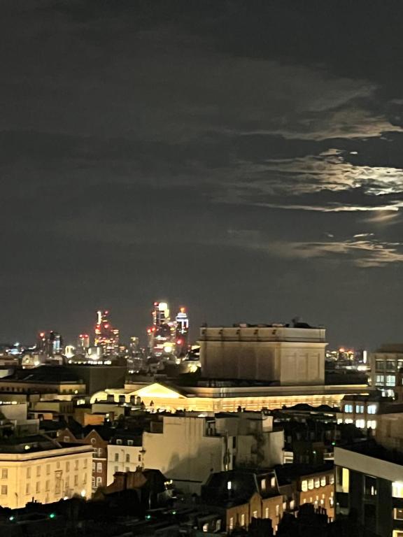 a view of a city at night at 2 Bed Ap Covent Garden in London