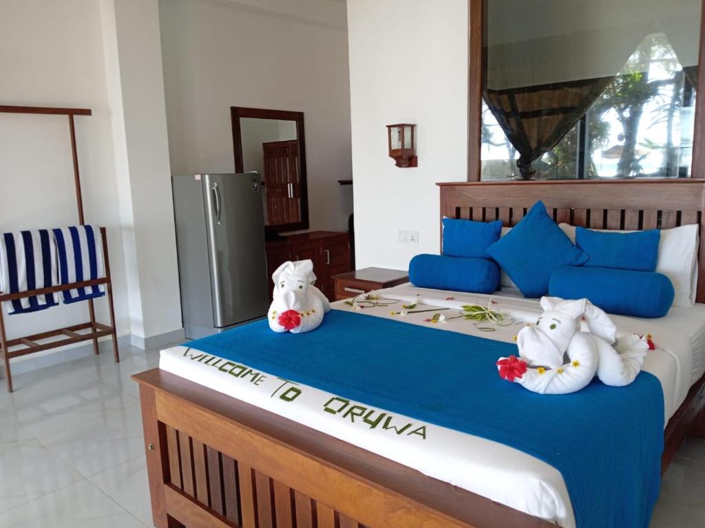 Postel nebo postele na pokoji v ubytování Oruwa Turtle Beach Villa