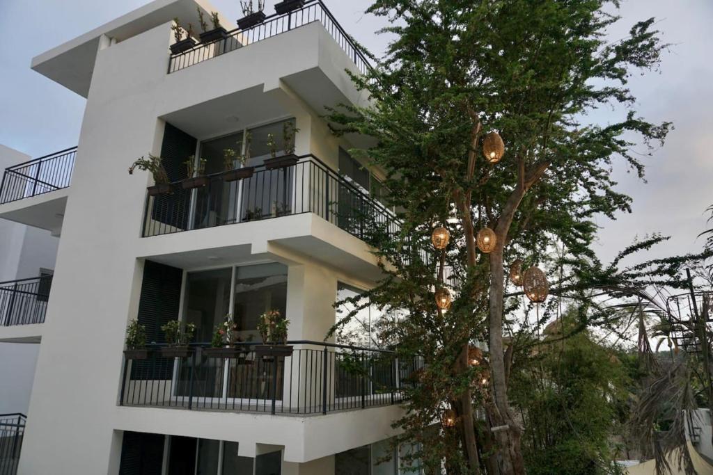 a white building with a christmas tree in front of it at Aqua Reef Condos Sayulita Apt 2 in Sayulita