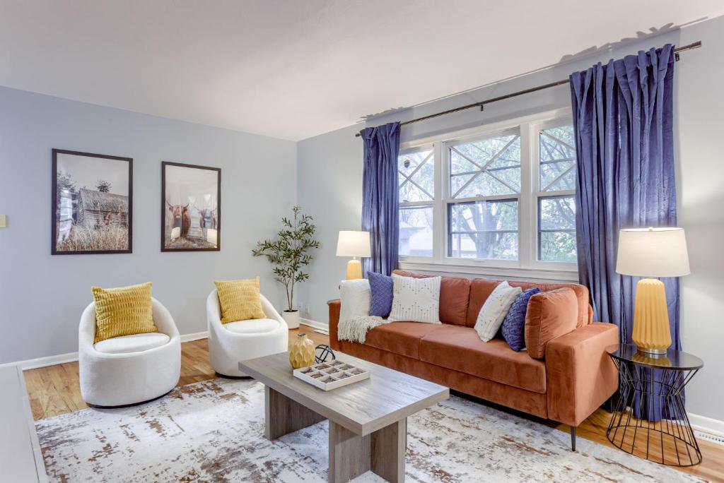 a living room with a couch and two chairs at Central 4BD Home - Spacious Backyard & Fun Games in Omaha