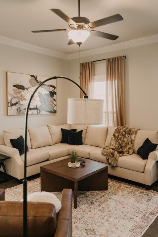 a living room with a couch and a ceiling fan at Long Term Stay Fast Wifi Comfortable in Lake Charles