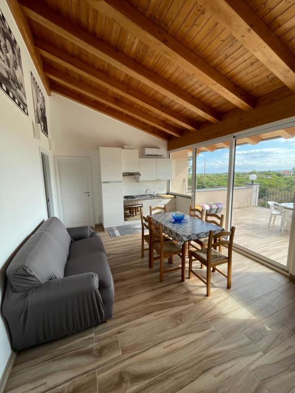 a living room with a couch and a table at Villetta Alcantara Apartment in Calatabiano