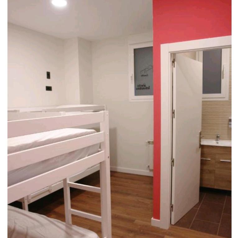 Łóżko lub łóżka w pokoju w obiekcie Hostel Trovadores