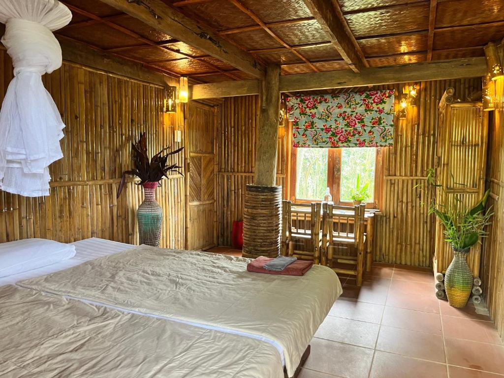 a bedroom with a bed in a room with wooden walls at PuBin Spice Hills in Hòa Bình