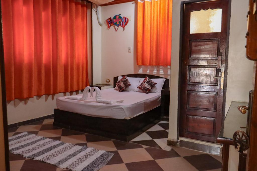 Postel nebo postele na pokoji v ubytování Nubian Kulih house