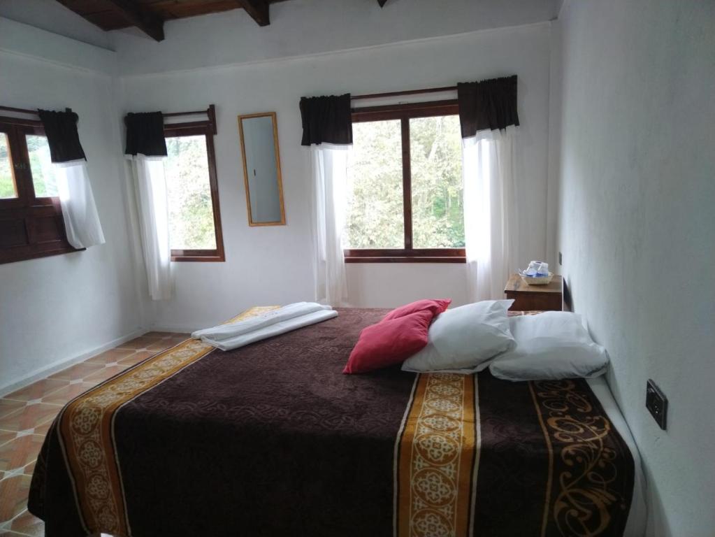 Postel nebo postele na pokoji v ubytování Hotel Coyopolan