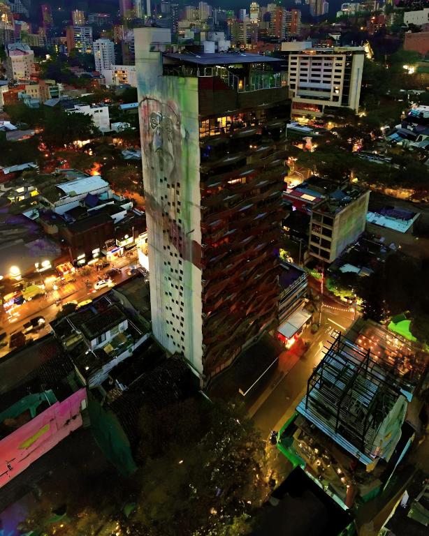 a tall building in a city at night at The Charlee Hotel in Medellín