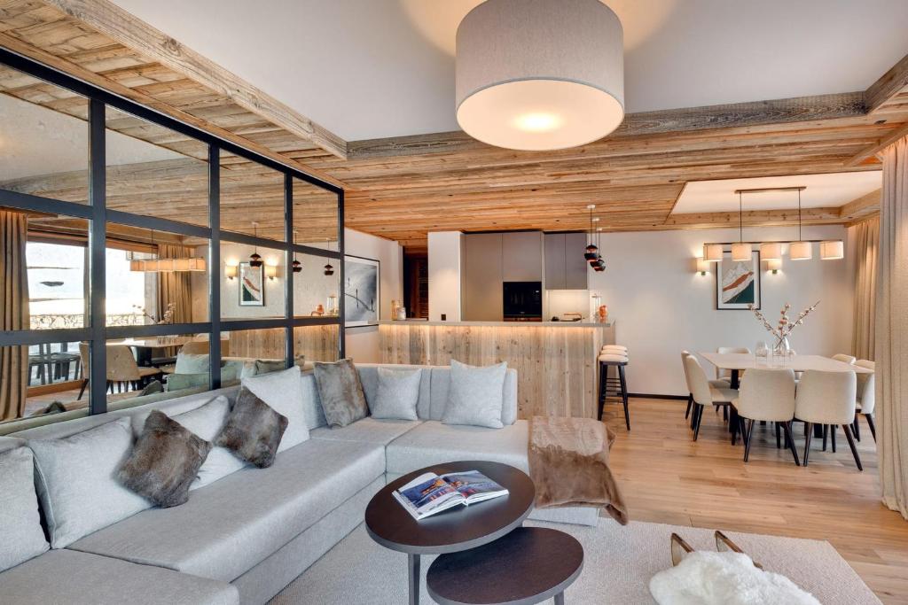 un soggiorno con un divano e un tavolo di Antarès MIRA 001 - deluxe apartment ski inski out a Méribel
