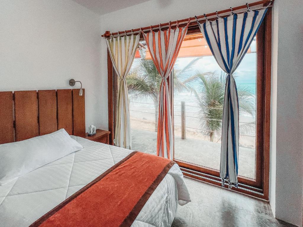 Postel nebo postele na pokoji v ubytování Mi Playa Galapagos Beachfront