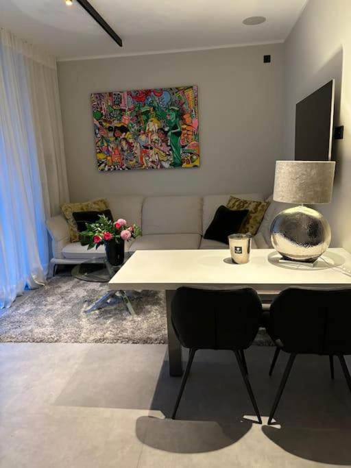 a living room with a table and two chairs at Wunderschöne Wohnung nahe Köln und Düsseldorf in Dormagen