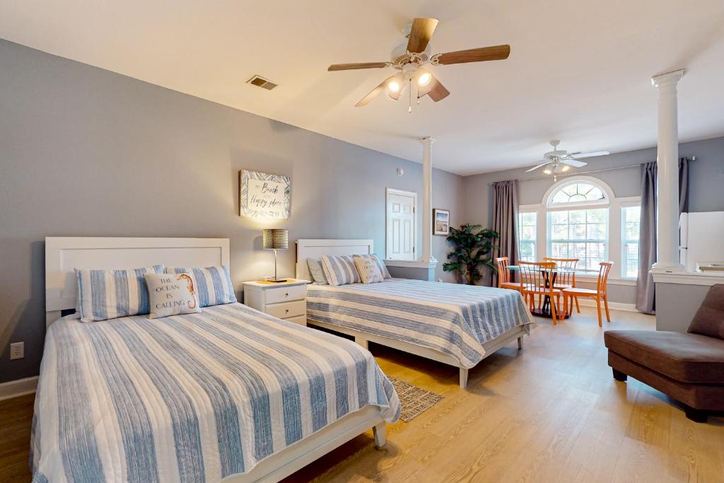 a bedroom with two beds and a ceiling fan at Sea Trail Golf-Beach Mini Suite in Sunset Beach