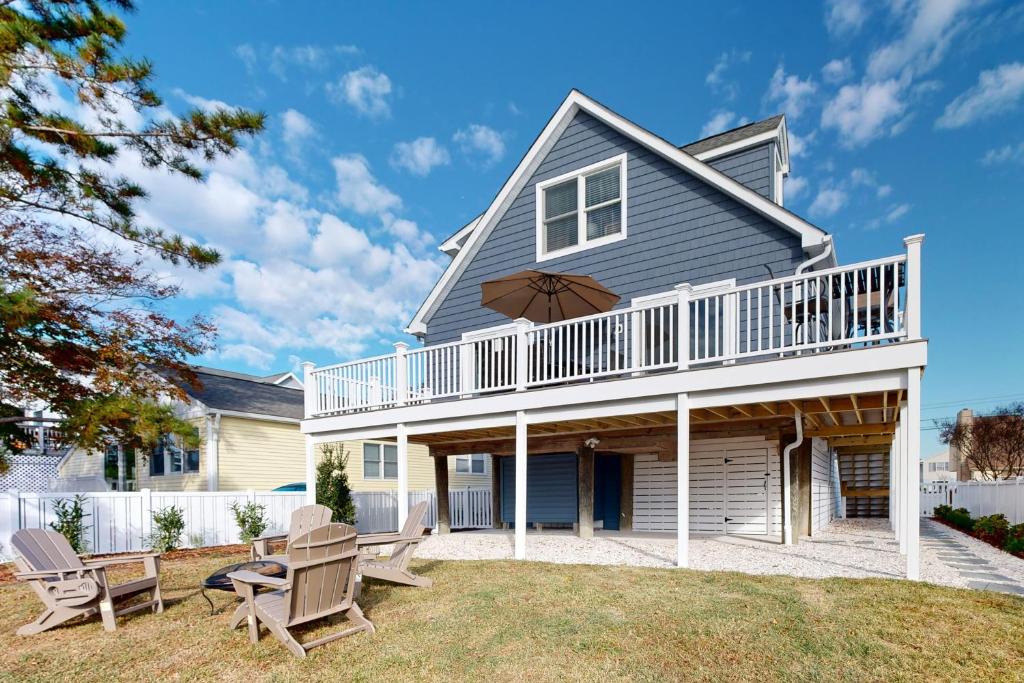 a house with a balcony and two chairs at South Bethany --- 106 Brandywine Drive in Bethany Beach