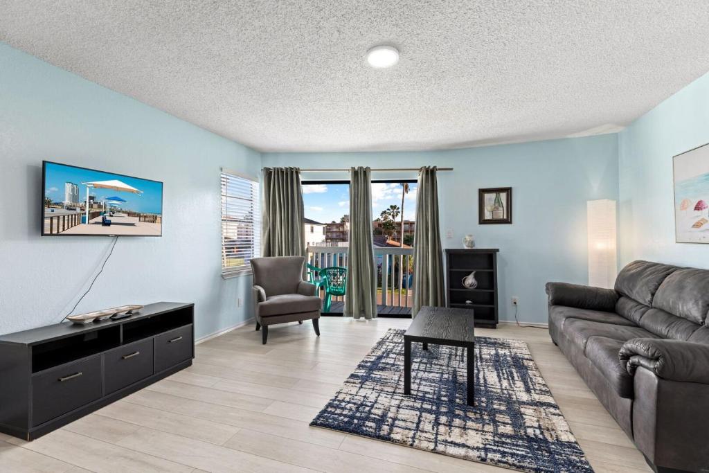a living room with a couch and a chair at 118 E Whiting St B Side in South Padre Island