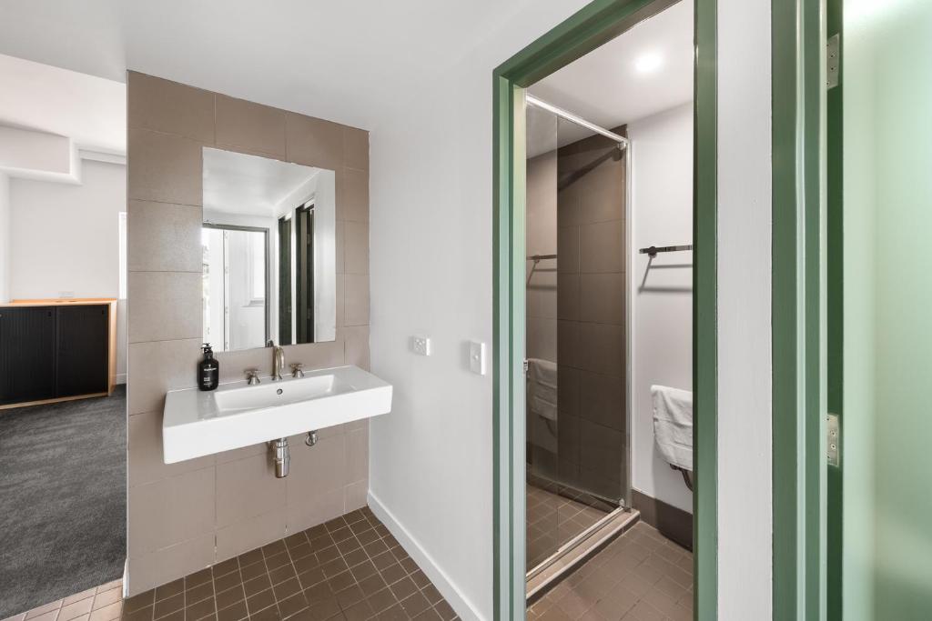 a bathroom with a sink and a mirror at YHA Sydney Harbour in Sydney