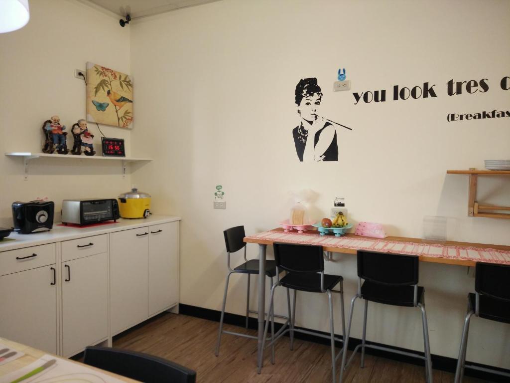 a kitchen with a counter with stools at Jia Mei Fa Homestay in Taitung City