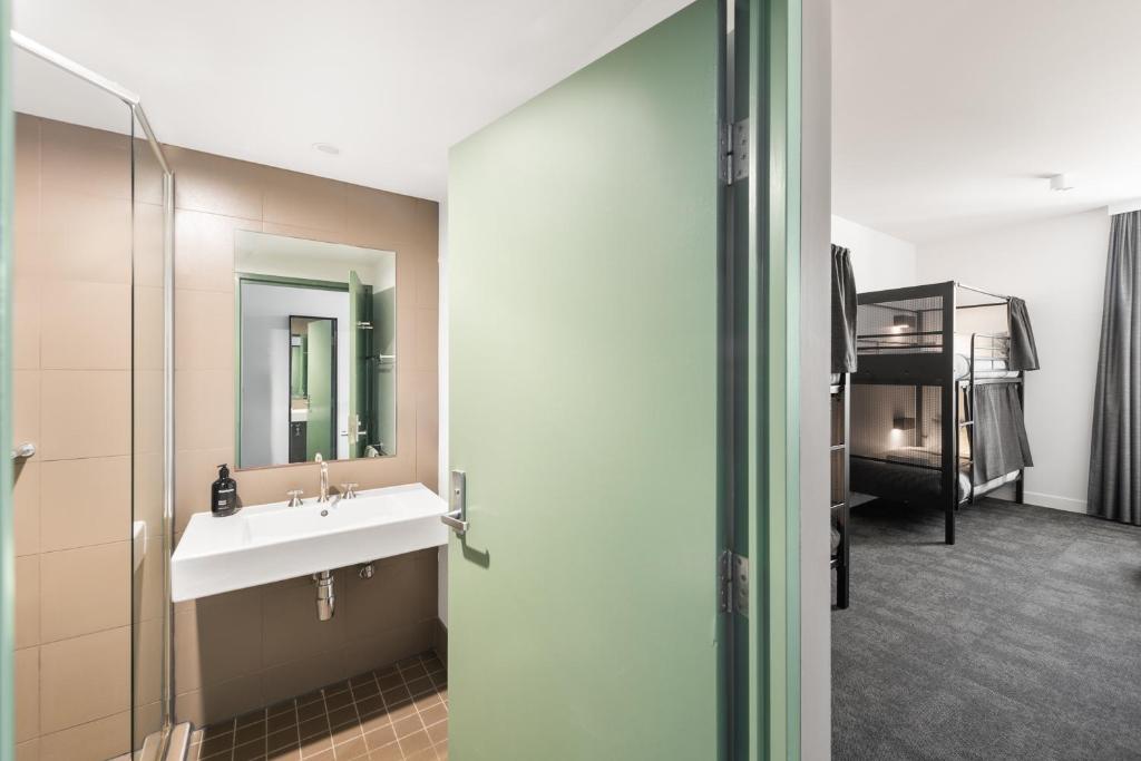 a bathroom with a sink and a mirror at YHA Sydney Harbour in Sydney