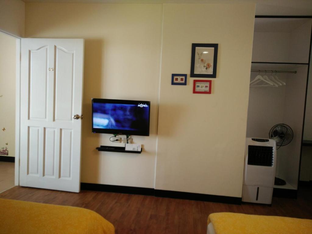 a living room with a flat screen tv on a wall at Jia Mei Fa Homestay in Taitung City