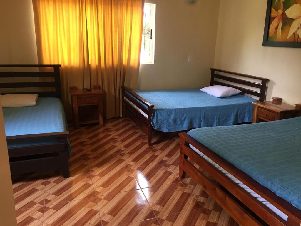 Postel nebo postele na pokoji v ubytování Finca Hotel La Ponderosa